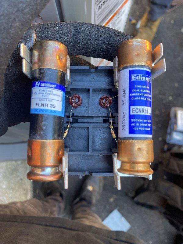 Completed installation of Trane air conditioning system as an add-on to existing HVAC infrastructure. Installed dual-element time-delay fuses (FLNR 35 amp and ECNR35 rated for 600V AC) in disconnect assembly to provide proper overcurrent protection for the new AC unit. Coordinated work with customer's electrical contractor who handled primary electrical connections. Routed refrigerant lines and condensate piping through existing concrete block wall opening to connect outdoor condenser unit to indoor air handler. All equipment tested and operational upon completion, with proper voltage verification and amperage draw confirmed within manufacturer specifications.