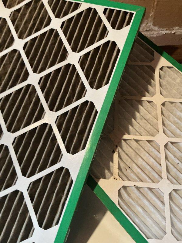 Completed comprehensive cooling system maintenance on residential HVAC unit. Replaced dirty air filter with new high-efficiency pleated filter, as evidenced by significant dust and debris accumulation on the original filter. Inspected outdoor condenser unit positioned on brick paver patio, confirmed proper refrigerant line insulation and verified unit operational status with no immediate service concerns noted.