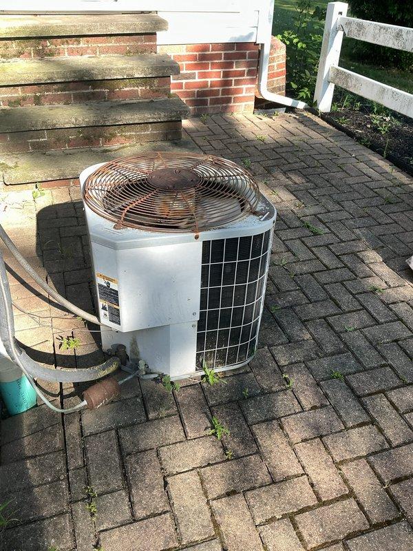 Completed comprehensive cooling system maintenance on residential HVAC unit. Replaced dirty air filter with new high-efficiency pleated filter, as evidenced by significant dust and debris accumulation on the original filter. Inspected outdoor condenser unit positioned on brick paver patio, confirmed proper refrigerant line insulation and verified unit operational status with no immediate service concerns noted.