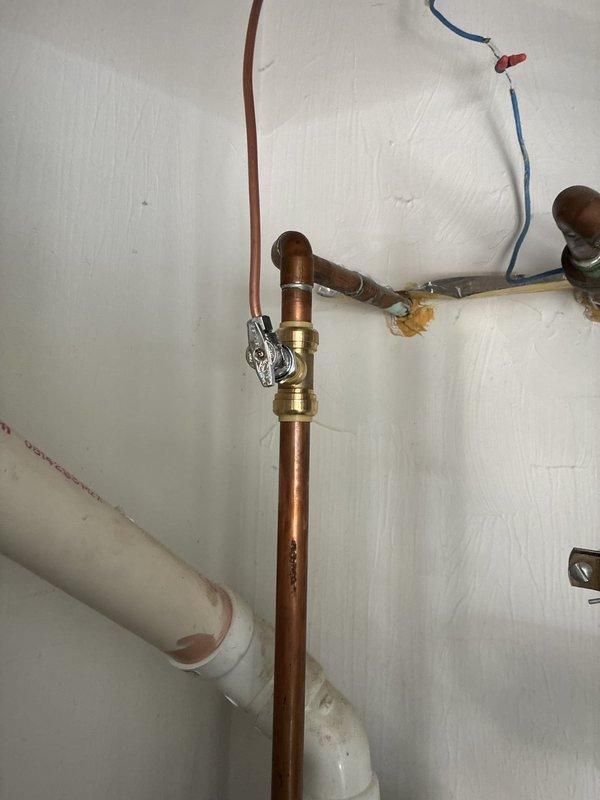 Removed and replaced prohibited saddle valve on humidifier water supply line with approved ball valve connection. Installed safety switch in mechanical area between water heater and furnace to meet code requirements and ensure proper system shutdown protection.
