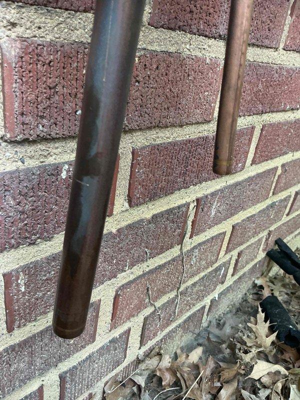 Disconnected residential air conditioning unit to allow for building waterproofing work on exterior brick wall. Upon completion of waterproofing, returned to site and reinstalled the AC system, reconnecting refrigerant lines, electrical connections, and verifying proper operation of the outdoor condensing unit.