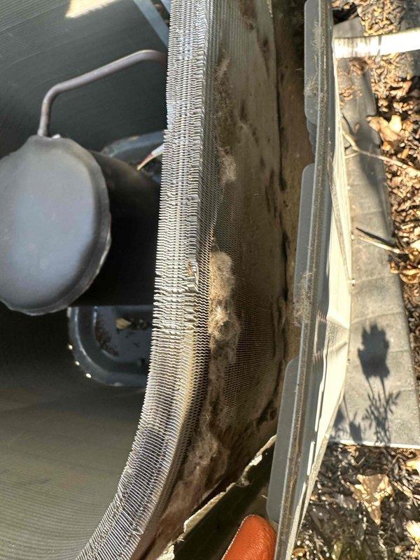 Performed comprehensive cleaning service on outdoor condensing unit that had accumulated excessive dirt, dust, and debris buildup. Thoroughly washed condenser coil fins to remove blockages and restore proper airflow, then cleaned compressor jacket and exterior surfaces to ensure optimal heat transfer and system efficiency.
