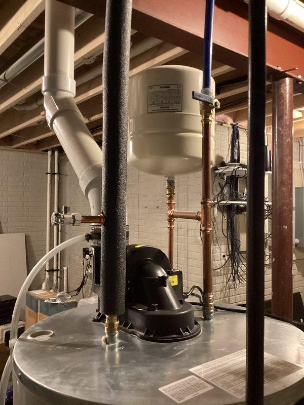 Performed routine maintenance flush and fill service on tanked water heater system. Drained sediment buildup from tank, refilled unit, and verified proper operation of all connected plumbing components including expansion tank, copper supply lines, and PVC drainage system.