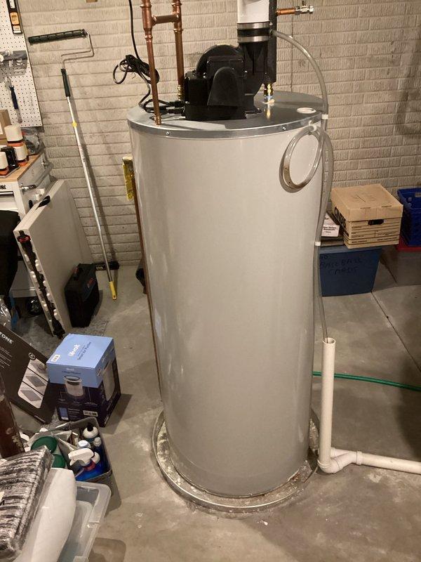 Performed routine maintenance flush and fill service on tanked water heater system. Drained sediment buildup from tank, refilled unit, and verified proper operation of all connected plumbing components including expansion tank, copper supply lines, and PVC drainage system.