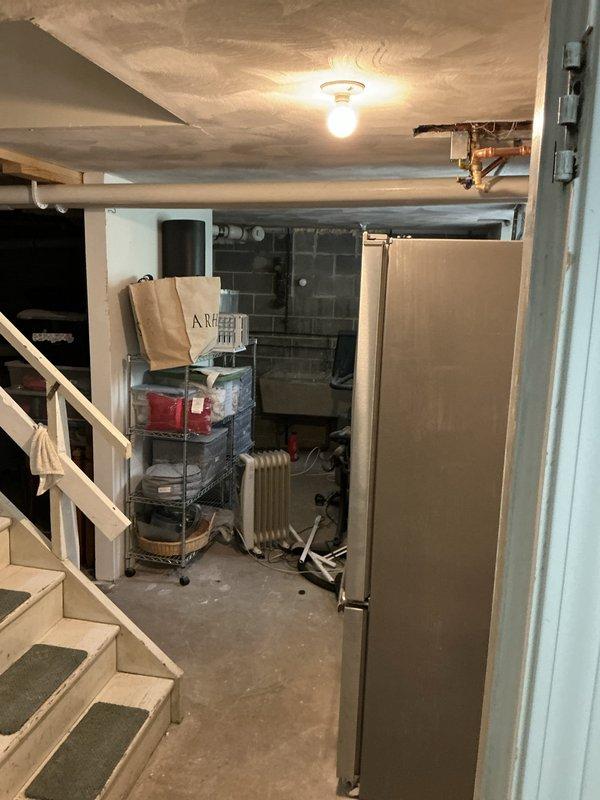 Conducted site assessment for mini split expansion in unfinished basement area. Customer currently has four head units installed on upper level and requested quote to extend coverage to lower level for whole-house comfort. Evaluated basement layout, including exposed ceiling joists, existing utilities, electrical panel location, and concrete block construction to determine optimal placement for additional indoor head units and refrigerant line routing from existing outdoor condenser.