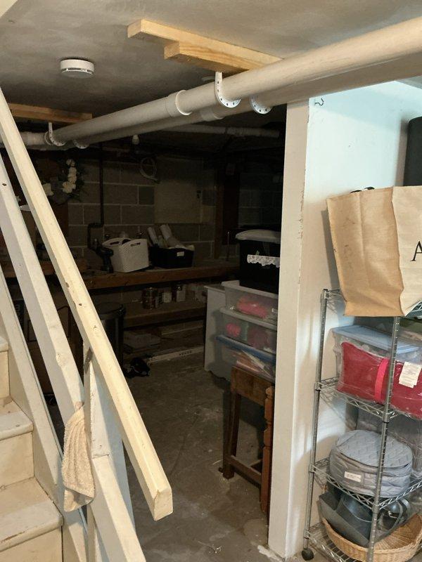 Conducted site assessment for mini split expansion in unfinished basement area. Customer currently has four head units installed on upper level and requested quote to extend coverage to lower level for whole-house comfort. Evaluated basement layout, including exposed ceiling joists, existing utilities, electrical panel location, and concrete block construction to determine optimal placement for additional indoor head units and refrigerant line routing from existing outdoor condenser.