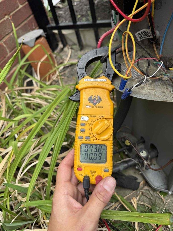 Responded to no-cooling call following reported brownout event. Upon arrival, confirmed thermostat was clicking but outdoor condensing unit failed to start. Performed electrical diagnostics using digital multimeter at outdoor unit terminal connections. Measured voltage at contactor and control circuits to identify power supply issues related to electrical surge damage. Testing revealed compromised electrical components preventing compressor and condenser fan operation. Documented equipment condition and electrical readings with photos showing wiring connections and voltage measurements at terminal block.