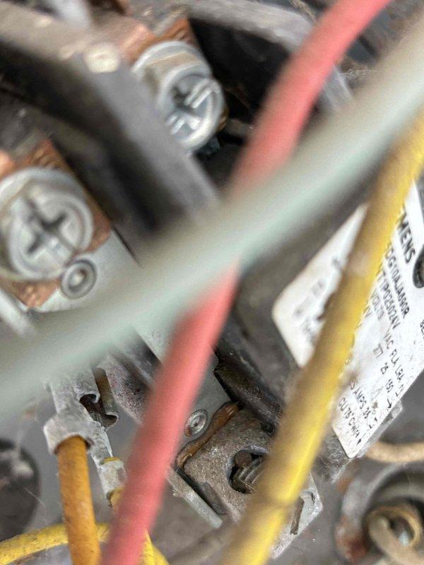 Completed comprehensive HVAC tune-up on system with visible dust and debris accumulation on electrical components and wiring connections. Inspected all electrical terminals, connections, and control wiring; documented existing conditions showing age-related oxidation on terminal blocks and connection points requiring monitoring for future service needs.
