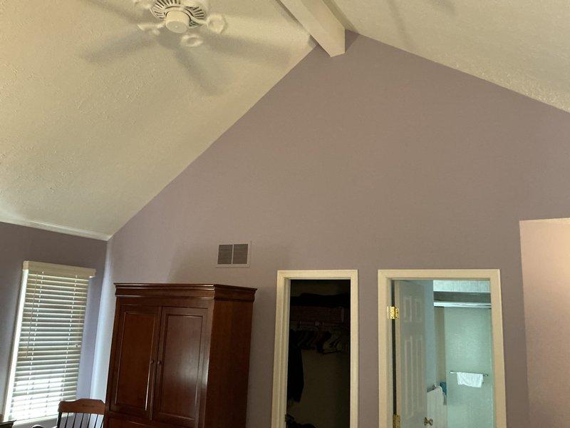 Conducted site assessment for mini-split air conditioning system installation in bedroom with vaulted ceiling. Evaluated room layout, electrical access via ceiling panel, and optimal placement for indoor unit considering existing ceiling fan and furniture arrangement. Provided estimate for standalone ductless AC unit to serve the space.