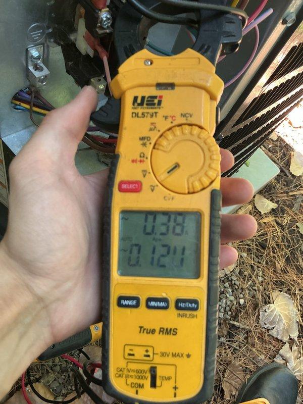 Completed cooling system tune-up on outdoor HVAC unit. Performed electrical diagnostics using digital multimeter to verify voltage and amperage readings at capacitor and compressor connections. System tested and operating within normal parameters.
