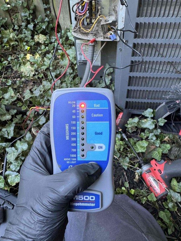 # Compressor Failure on 11-Year-Old Rheem Air Conditioning Unit

Responded to service call for insufficient cooling on an 11-year-old Rheem air conditioning system. Upon arrival, performed diagnostic testing of the outdoor condensing unit. Used megohmmeter to test compressor insulation resistance and motor windings. Testing revealed compressor failure, with readings in the "Bad" range indicating electrical breakdown within the compressor motor.

Inspected electrical components including contactor, circuit breakers, and associated wiring at both the outdoor unit and indoor electrical panel. Verified all electrical connections and control circuits were functioning properly. Determined that the compressor motor had failed internally, resulting in inadequate cooling performance.

Documented findings with diagnostic photos showing failed megohmmeter test results and electrical system configuration. Provided customer with repair options and recommendations for compressor replacement to resto