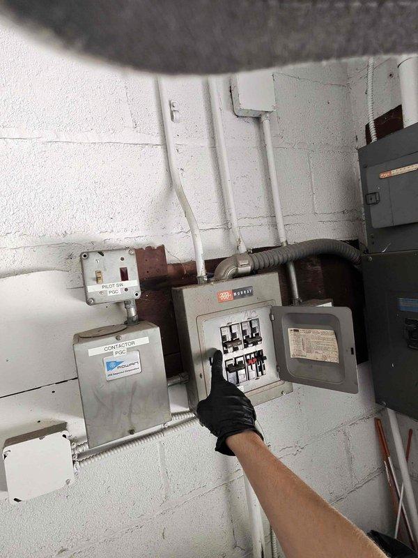 # Compressor Failure on 11-Year-Old Rheem Air Conditioning Unit

Responded to service call for insufficient cooling on an 11-year-old Rheem air conditioning system. Upon arrival, performed diagnostic testing of the outdoor condensing unit. Used megohmmeter to test compressor insulation resistance and motor windings. Testing revealed compressor failure, with readings in the "Bad" range indicating electrical breakdown within the compressor motor.

Inspected electrical components including contactor, circuit breakers, and associated wiring at both the outdoor unit and indoor electrical panel. Verified all electrical connections and control circuits were functioning properly. Determined that the compressor motor had failed internally, resulting in inadequate cooling performance.

Documented findings with diagnostic photos showing failed megohmmeter test results and electrical system configuration. Provided customer with repair options and recommendations for compressor replacement to resto