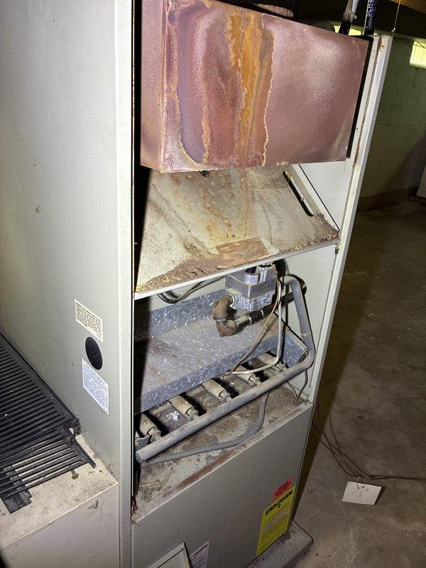 Conducted full system replacement estimate for residential HVAC unit. Inspection revealed severely corroded heat exchanger with extensive rust throughout upper chamber and burner assembly, indicating prolonged moisture exposure and potential safety concerns. Documented internal component condition and provided homeowner with comprehensive replacement options for complete system upgrade.