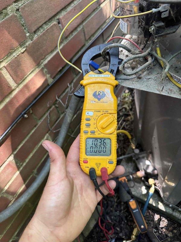 Responded to no-cooling call on 10-year-old outdoor AC unit with complete loss of power and inoperative condenser fan. Performed electrical diagnostics using clamp meter, measuring voltage and amperage at unit's electrical connections. Conducted comprehensive system evaluation using digital manifold gauges to monitor R410A refrigerant pressures, recording 126.6 psi suction pressure (43.5°F saturation) and 261.7 psi discharge pressure (86.6°F saturation), with superheat at 13.7°F and subcooling at 12.3°F, indicating system was operational following repair. Restored power to unit and verified proper system operation with all readings within normal parameters.