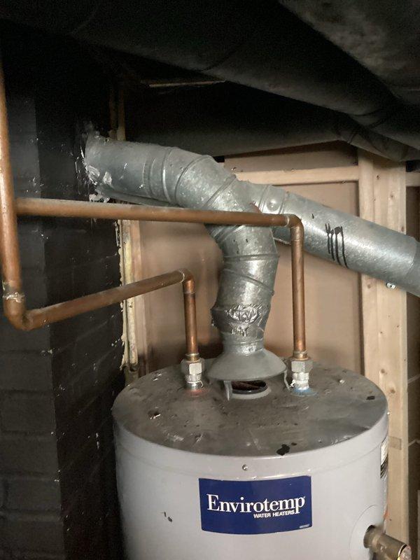 Responded to service call for Envirotemp tanked water heater experiencing internal tank leak causing pilot flame extinguishment. Upon inspection, confirmed water leakage from inside the tank contaminating the burner assembly and preventing proper ignition. Unit determined to be beyond economical repair due to compromised tank integrity requiring full replacement.