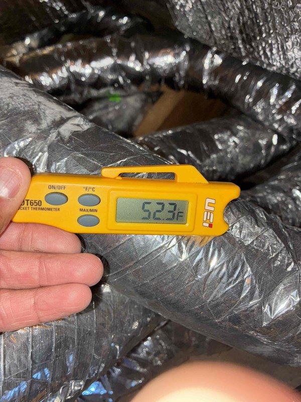 Completed cooling tune-up on residential HVAC system. Connected manifold gauges to outdoor condensing unit and verified refrigerant pressures and system operation. Measured supply air temperature at 52.3°F in ductwork, confirming proper cooling performance and adequate temperature split across evaporator coil.
