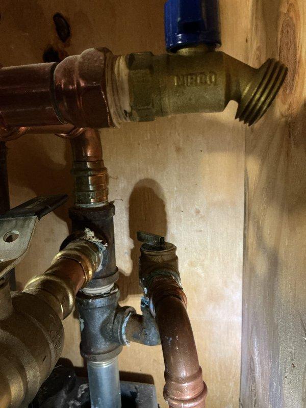 Replaced defective pressure relief valve on residential boiler system. Removed old valve, installed new NIBCO brass pressure relief valve with proper threaded connections, and verified all copper supply line connections were secure and leak-free. System tested and confirmed operating safely within normal pressure parameters.