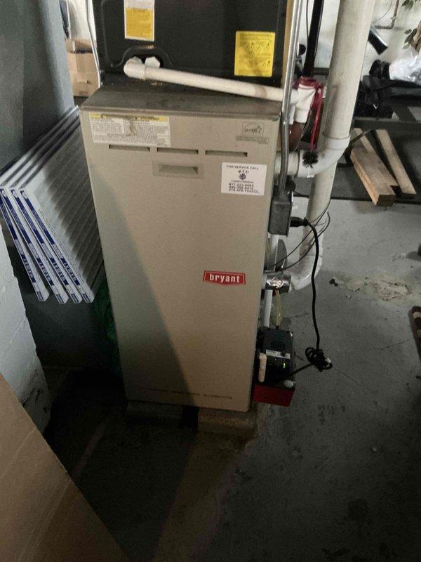 Conducted residential HVAC estimate for furnace replacement at property with existing Bryant brand unit installed in basement mechanical room. Documented current system configuration including ductwork connections, electrical components, and associated air handler equipment. Photographed existing installation to provide homeowner with replacement options and system upgrade recommendations.