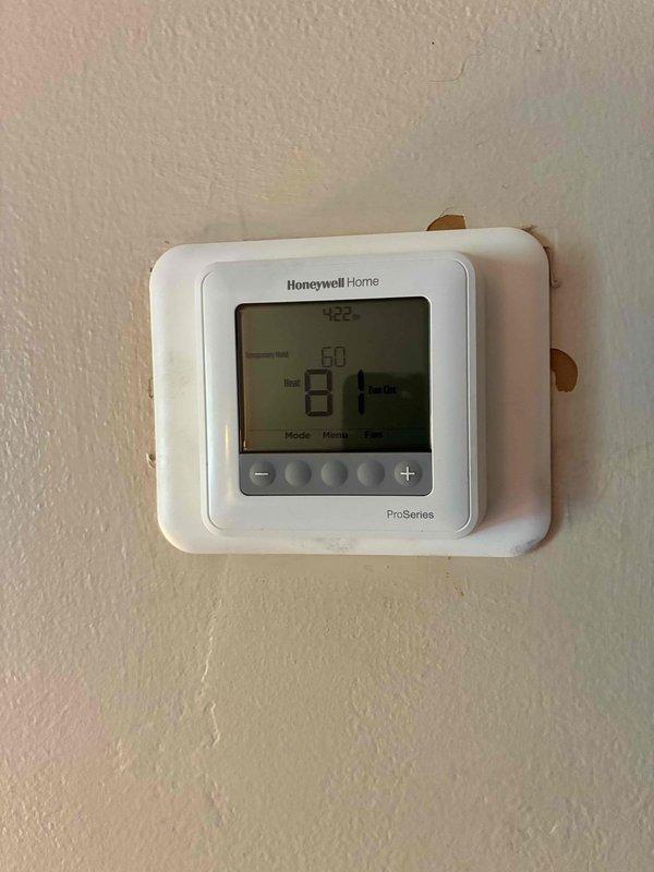 Completed furnace installation with 80% efficiency unit requiring 90-degree rotation for proper positioning. Extended gas line and replaced flue pipe to accommodate new configuration. Installed and programmed Honeywell Home ProSeries thermostat, verified system operation and proper heating function upon completion.