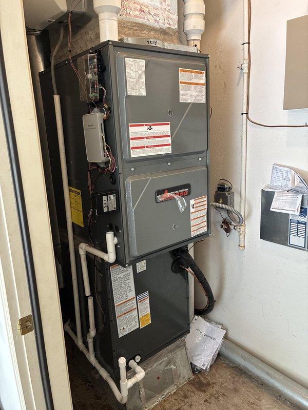 Completed full HVAC system installation consisting of a 96% efficiency downflow furnace paired with a CAPTA24X6A3AA heat pump/air conditioner unit manufactured in 2020. The system was configured in a vertical stack arrangement within an interior utility closet. Installation included proper integration of all refrigerant lines, electrical connections to dedicated panel, PVC condensate drainage piping routed vertically, and copper refrigerant line sets with appropriate insulation. All safety labels and manufacturer specifications were verified and remain visible on equipment. System was pressure tested, refrigerant charge confirmed to specifications, and all mechanical and electrical connections secured per code requirements.