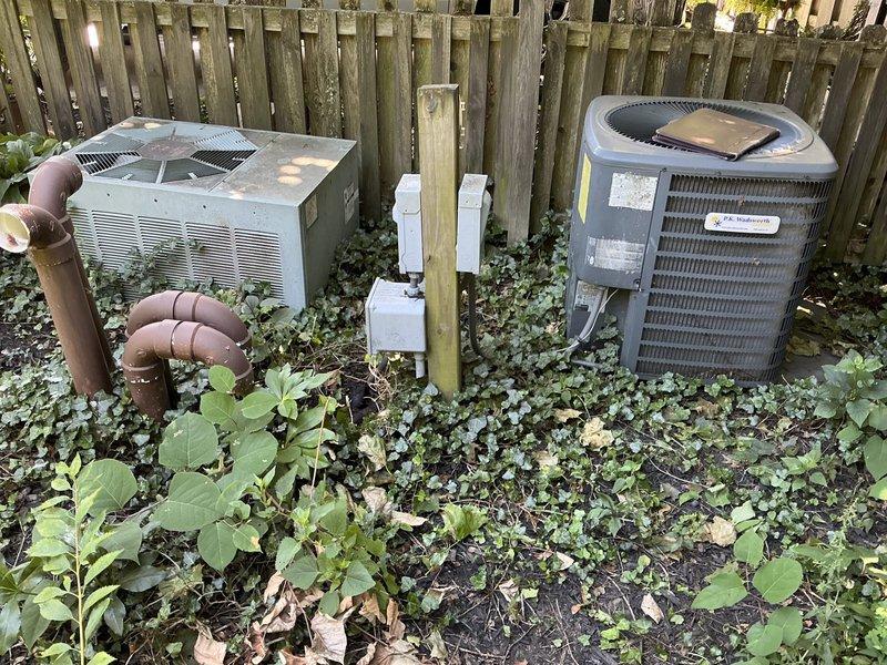 Conducted on-site assessment for twinned air conditioning system replacement. Evaluated existing indoor air handler unit located in garage utility space and dual outdoor condenser configuration consisting of one traditional box-style unit and one cylindrical unit positioned along exterior fence line. Documented current equipment condition, ductwork connections, condensate drainage system with PVC piping, and refrigerant line routing between indoor and outdoor components. Provided comprehensive replacement options for the twinned system setup to address customer's cooling needs.