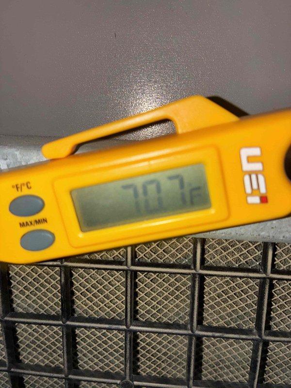 Responded to no cooling complaint on residential air conditioning unit. Upon arrival, measured supply air temperature at 70.7°F, confirming inadequate cooling performance. Inspected outdoor condensing unit, which showed signs of weathering with visible staining and minor corrosion on top panel, though protective grilles remained intact with no major debris accumulation.