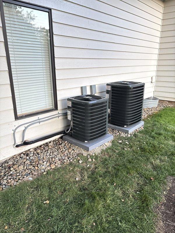 Completed installation of two air conditioning systems including relocation of condenser units to exterior side of residence. Both condensers were positioned on concrete pads with proper clearances and secured refrigerant line sets routed through exterior wall. Installed soft start kits on both units to reduce initial power draw and extend compressor life. Ran new electrical circuits from main panel to both outdoor units with appropriate wire gauge and overcurrent protection. Connected refrigerant lines to indoor air handlers in basement mechanical room, evacuated systems, and charged with manufacturer-specified refrigerant. Verified proper airflow, temperature differential, and electrical parameters on both systems. All equipment tested and confirmed operational.
