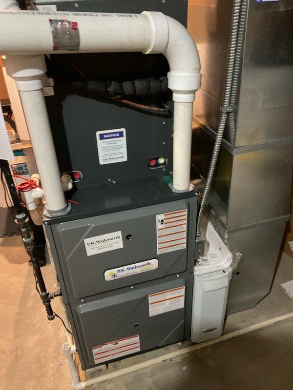 Completed scheduled preventive maintenance on residential cooling system equipped with P.K. Wadsworth furnace and air conditioning unit. Performed comprehensive system inspection including capacitor testing (45+5μf dual run capacitor), scroll compressor diagnostics with digital testing equipment, electrical connection verification across all colored wire terminals, and condensate drainage system evaluation of PVC piping. All components operating within manufacturer specifications with no deficiencies noted.