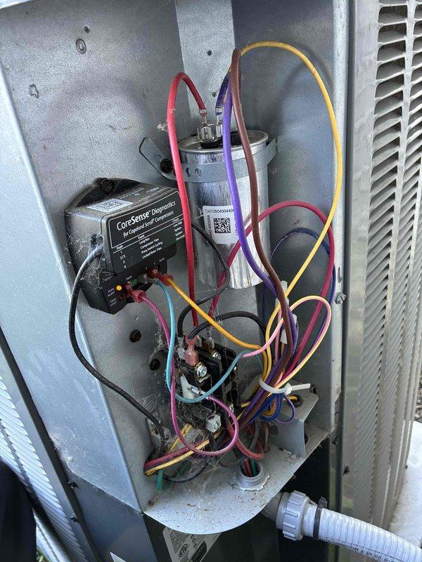 Completed scheduled preventive maintenance on residential cooling system. Performed comprehensive inspection of outdoor condensing unit, including examination of electrical components, capacitor connections, and surge protection device. All wiring connections were verified secure, capacitor tested within normal operating parameters, and CorSelect HF Defender surge protector confirmed operational. Unit operating efficiently with no deficiencies noted.