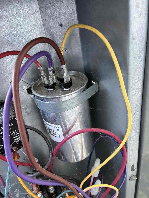 Completed scheduled preventive maintenance on residential cooling system. Performed comprehensive inspection of outdoor condensing unit, including examination of electrical components, capacitor connections, and surge protection device. All wiring connections were verified secure, capacitor tested within normal operating parameters, and CorSelect HF Defender surge protector confirmed operational. Unit operating efficiently with no deficiencies noted.