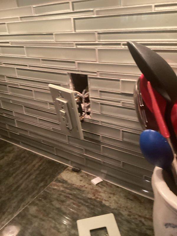 Responded to emergency service call for smoking electrical outlet in kitchen near stove. Upon arrival, found damaged receptacle with visible burn marks and compromised wiring connections. Disconnected power at main electrical panel, removed faulty outlet, tested circuit for additional damage, and installed new GFCI-protected receptacle per code requirements. Verified proper grounding, confirmed all connections were secure, and tested circuit operation to ensure safe functionality.