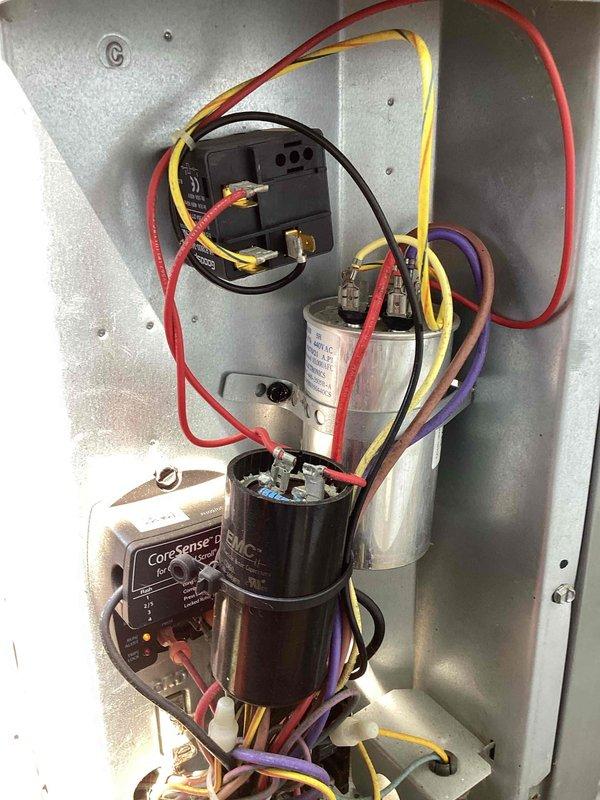 Completed scheduled cooling system preventive maintenance inspection on residential air conditioning unit. Thoroughly inspected electrical control panel components including capacitors, relays, and CoreSense monitoring device; verified all wire connections and terminals were secure with no signs of loose connections or excessive wear. All electrical components tested within normal operating parameters and system cycled properly during inspection.