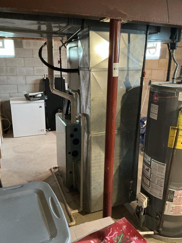 Conducted on-site assessment of existing HVAC system in residential basement mechanical room to provide equipment replacement options. Documented current furnace and surrounding utility infrastructure, including water heater, support columns, and available clearances for new equipment installation. Photographed existing conditions to develop accurate replacement proposal specifications.