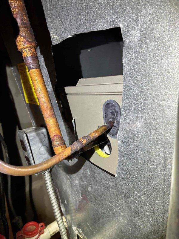 Responded to service call for air conditioning system experiencing progressive water leakage. Upon inspection, identified severely corroded copper refrigerant lines within the air handler cabinet, exhibiting extensive rust and oxidation damage with compromised pipe integrity. The deterioration showed evidence of prolonged moisture exposure and active corrosion at connection points to the control box assembly. Documented existing conditions with photographic evidence showing the extent of copper pipe degradation and associated water damage in the mechanical area.