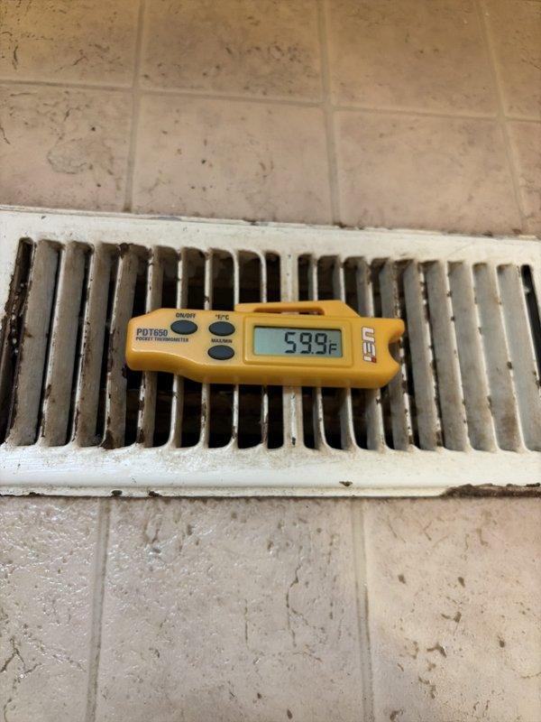 Completed scheduled cooling system maintenance on residential HVAC unit. Inspected and verified proper operation of dual-run capacitor (35+5 MFD), confirmed all electrical connections secure at terminal block. Measured supply air temperature at floor register reading 53.8°F, indicating adequate cooling performance and proper refrigerant charge. Assisted customer with locating main water shut-off valve, identified in laundry room area as requested.