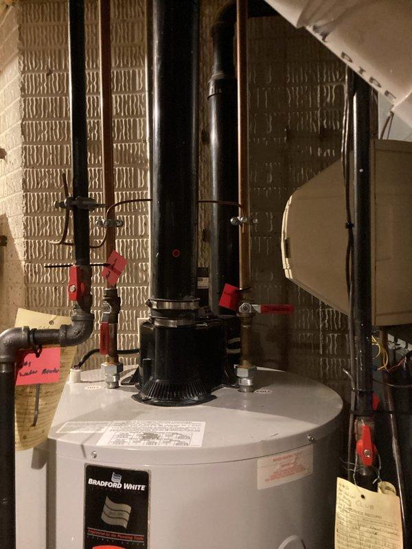 Performed routine maintenance flush on Bradford White tanked water heater to remove sediment buildup and ensure optimal performance. Drained tank completely using garden hose, inspected all plumbing connections and shut-off valves, verified proper venting system operation, and refilled unit to restore hot water service.