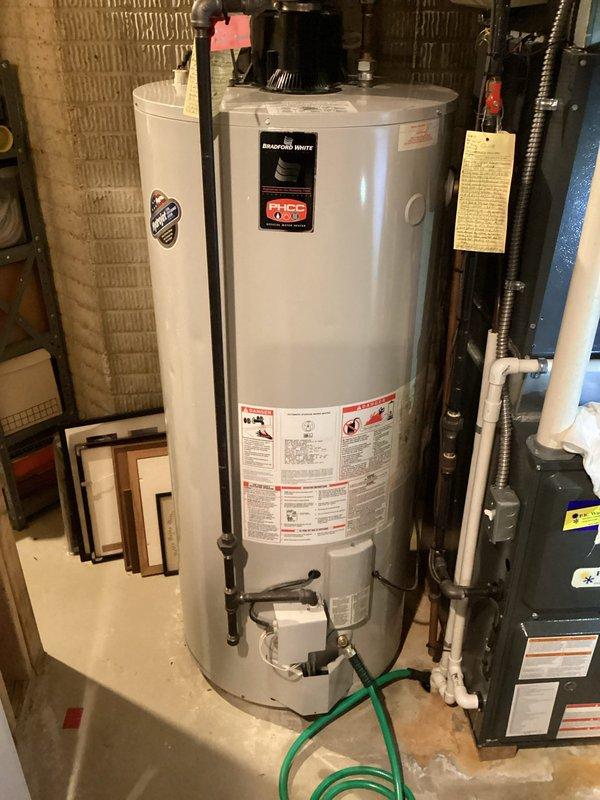 Performed routine maintenance flush on Bradford White tanked water heater to remove sediment buildup and ensure optimal performance. Drained tank completely using garden hose, inspected all plumbing connections and shut-off valves, verified proper venting system operation, and refilled unit to restore hot water service.