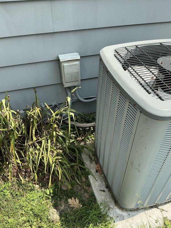 Completed air conditioning system evaluation and provided replacement options for existing equipment. The existing furnace, which was replaced a few years ago, remains in good operational condition with properly installed ductwork and plenum connections. The outdoor condensing unit shows signs of age and vegetation encroachment requiring clearance for optimal airflow and efficiency.