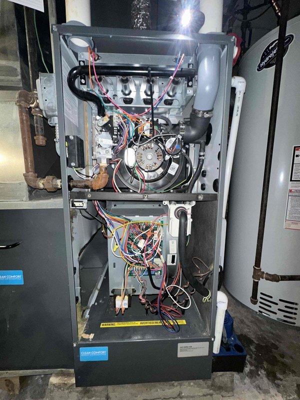 Completed scheduled cooling system maintenance on residential HVAC unit. Performed comprehensive inspection of air handler assembly, including blower motor, fan wheel, and electrical connections. Verified proper operation of control board and all associated wiring terminals. Measured amperage draw using clamp meter, confirming system operating within manufacturer specifications at 104.26 amps DC. Inspected condensate drain system and PVC piping for proper drainage. All components found to be functioning correctly with no immediate service needs identified.
