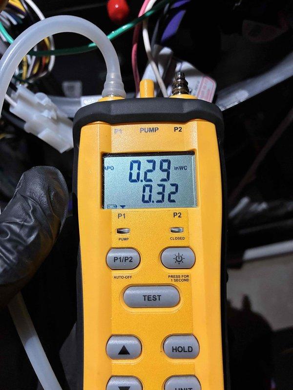 Performed quality check and diagnostic testing on HVAC system. Measured gas pressure at 0.29-0.32 inches water column using digital manometer and recorded electrical readings of 45.1 with True RMS power clamp meter on system components including capacitor. Documented all findings with photos for service records.