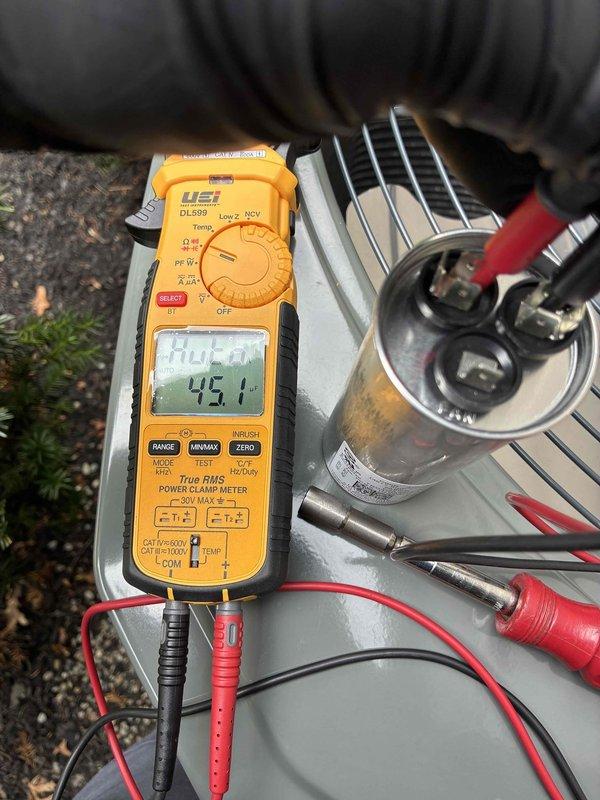 Performed quality check and diagnostic testing on HVAC system. Measured gas pressure at 0.29-0.32 inches water column using digital manometer and recorded electrical readings of 45.1 with True RMS power clamp meter on system components including capacitor. Documented all findings with photos for service records.