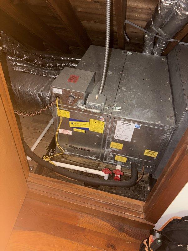 Completed routine cooling maintenance on residential attic-mounted HVAC system. Inspected heating unit, ductwork connections, and refrigerant line components including service valves with protective caps. All equipment found in operational condition with standard wear patterns consistent with regular use.