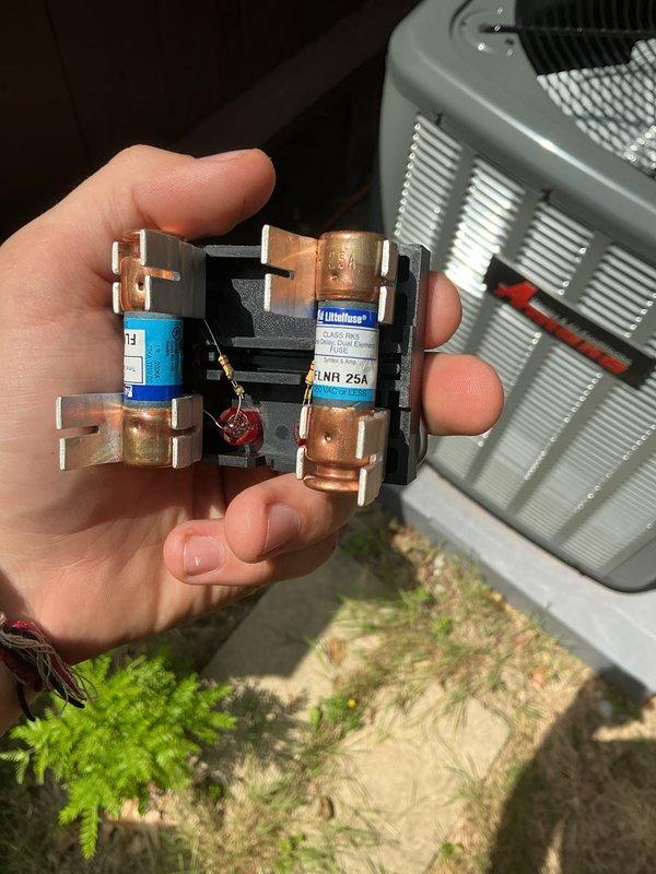 Responded to concerns regarding high amperage readings flagged by state inspector as potential fire hazard. Conducted comprehensive electrical load calculations for split power home with 200-amp exterior main disconnect feeding two 100-amp sub-panels. Assessment confirmed maximum power pull of 133 amps with basement section accounting for 50 amps of total load. Verified new Trane AC unit specifications showing 13.4-amp running load and 59.3-amp startup amperage compared to previous unit's 13-amp running load and 58-amp startup. Inspected and documented fuse block assembly with Littelfuse Class R 25A rated fuses and associated electrical components at exterior disconnect. Confirmed proper installation of contactor relay device and all electrical connections to HVAC system. System operating within acceptable parameters for home's electrical capacity.