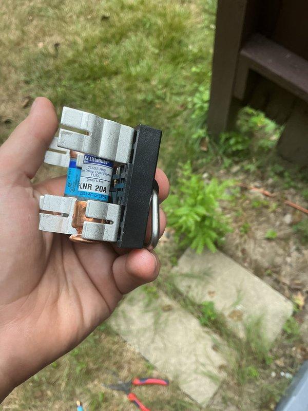 Responded to concerns regarding high amperage readings flagged by state inspector as potential fire hazard. Conducted comprehensive electrical load calculations for split power home with 200-amp exterior main disconnect feeding two 100-amp sub-panels. Assessment confirmed maximum power pull of 133 amps with basement section accounting for 50 amps of total load. Verified new Trane AC unit specifications showing 13.4-amp running load and 59.3-amp startup amperage compared to previous unit's 13-amp running load and 58-amp startup. Inspected and documented fuse block assembly with Littelfuse Class R 25A rated fuses and associated electrical components at exterior disconnect. Confirmed proper installation of contactor relay device and all electrical connections to HVAC system. System operating within acceptable parameters for home's electrical capacity.