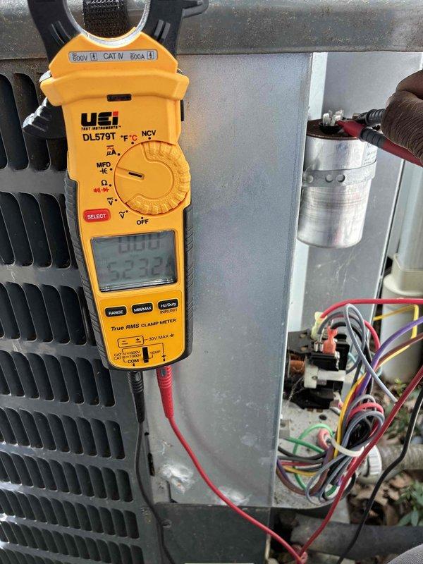 # HVAC Cooling Maintenance Completed

Performed routine preventive maintenance on residential air conditioning system as part of recurring service agreement. Conducted comprehensive electrical diagnostics using digital clamp meter, measuring amperage draw and verifying proper electrical parameters at the condenser unit. All electrical readings, including 323.2 amp measurement, were within manufacturer specifications. Inspected condenser unit exterior condition, verified proper airflow through louvered fins, and confirmed unit operational status on concrete pad with adequate clearance from structure.