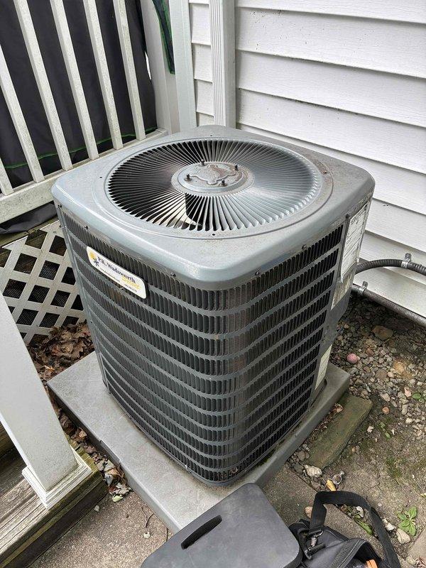 # HVAC Cooling Maintenance Completed

Performed routine preventive maintenance on residential air conditioning system as part of recurring service agreement. Conducted comprehensive electrical diagnostics using digital clamp meter, measuring amperage draw and verifying proper electrical parameters at the condenser unit. All electrical readings, including 323.2 amp measurement, were within manufacturer specifications. Inspected condenser unit exterior condition, verified proper airflow through louvered fins, and confirmed unit operational status on concrete pad with adequate clearance from structure.