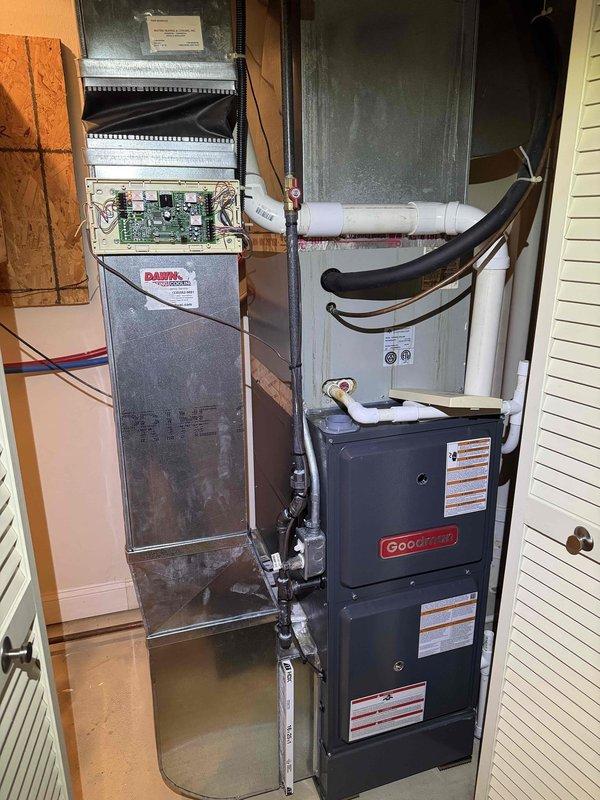 Responded to customer complaint regarding air conditioning system overcooling and not matching thermostat setpoint. Inspected indoor air handler unit with exposed control board and outdoor Goodman condensing unit. Diagnosed and addressed thermostat calibration issue causing temperature differential between set point and actual cooling output, restoring proper system operation and temperature control.