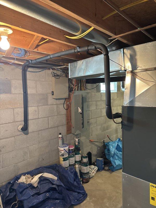 Completed installation of new air conditioning system including outdoor condensing unit positioned on concrete pad with proper clearances. Installed refrigerant line set, electrical disconnect, and conduit from exterior disconnect box to unit. Routed ductwork through basement area connecting to existing infrastructure, secured all runs to ceiling joists with appropriate hangers and supports. Verified electrical connections, tested system operation, and collected full payment upon successful completion.