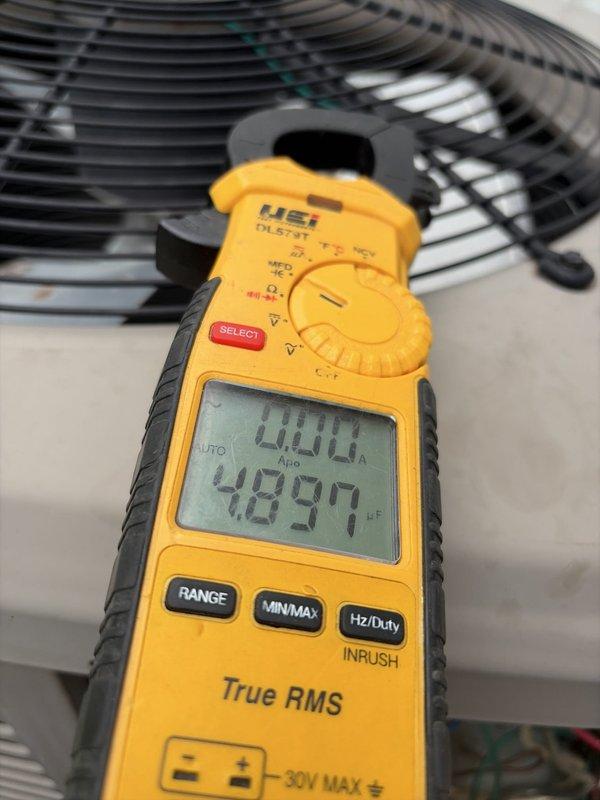 Completed HVAC cooling tune-up on rooftop unit. Inspected exterior disconnect switch, confirmed proper operation and secure mounting. Performed electrical diagnostics using digital multimeter, recording amperage draw of 48.94 amps on compressor circuit. Verified all electrical connections at disconnect box, checked condenser fan motor operation, and confirmed system operating within normal parameters.