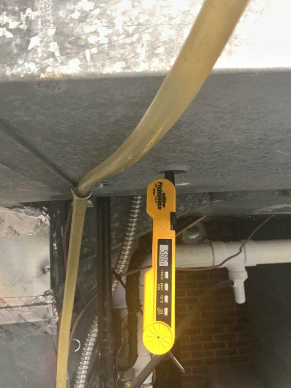 Responded to service call for residential air conditioning system reported to have diminished cooling performance. Performed comprehensive seasonal cooling maintenance inspection on outdoor condenser unit and indoor air handler system. Conducted diagnostic temperature measurements at air handler using calibrated digital thermometer to assess system performance and airflow temperatures. Visually inspected outdoor condenser unit positioned on mounting pad, verified proper clearance from surrounding vegetation, and checked electrical disconnect box and conduit connections. Evaluated indoor air handler installation in attic space, including ductwork connections and flexible supply ducts. System operational parameters were measured and recorded to determine cooling efficiency and identify any performance deficiencies requiring corrective action.